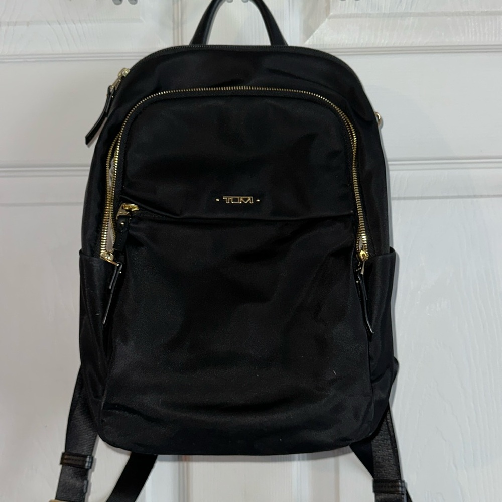 In good used condition. Tumi backpack style purse.